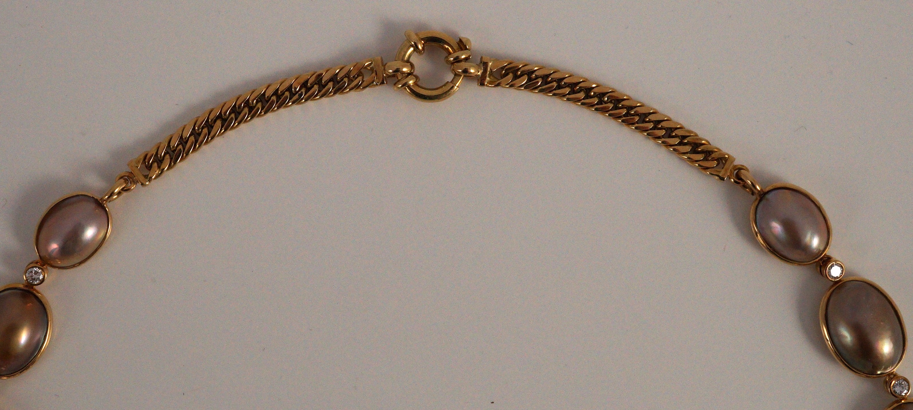 A cased modern single strand graduated shaped mabe pearl and round brilliant cut diamond set drop necklace, with 18ct gold clasp and chain section